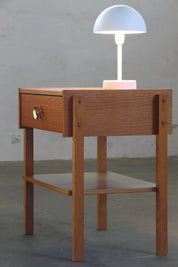 Scandinavian_Oak_Bedside_Table_with_Brass-Tone_Handle_and_Tapered_Legs,_1970s