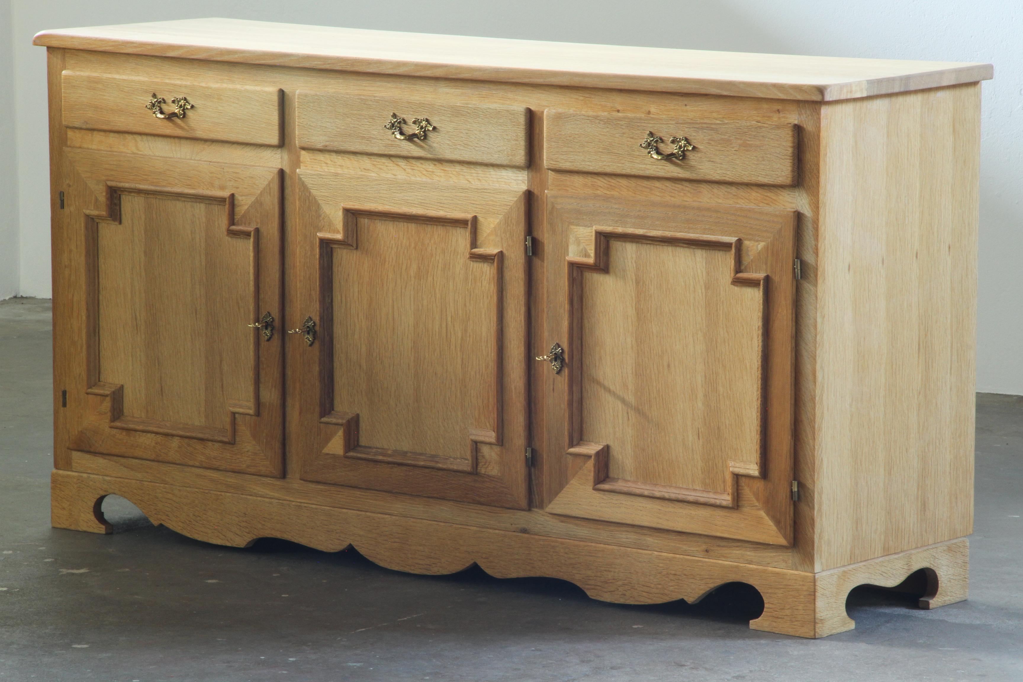 Danish_Brutalist_Solid_Oak_Sideboard_with_Carved_Doors_and_Three_Drawers,_Attributed_to_Henning_Kjærnulf,_1960s