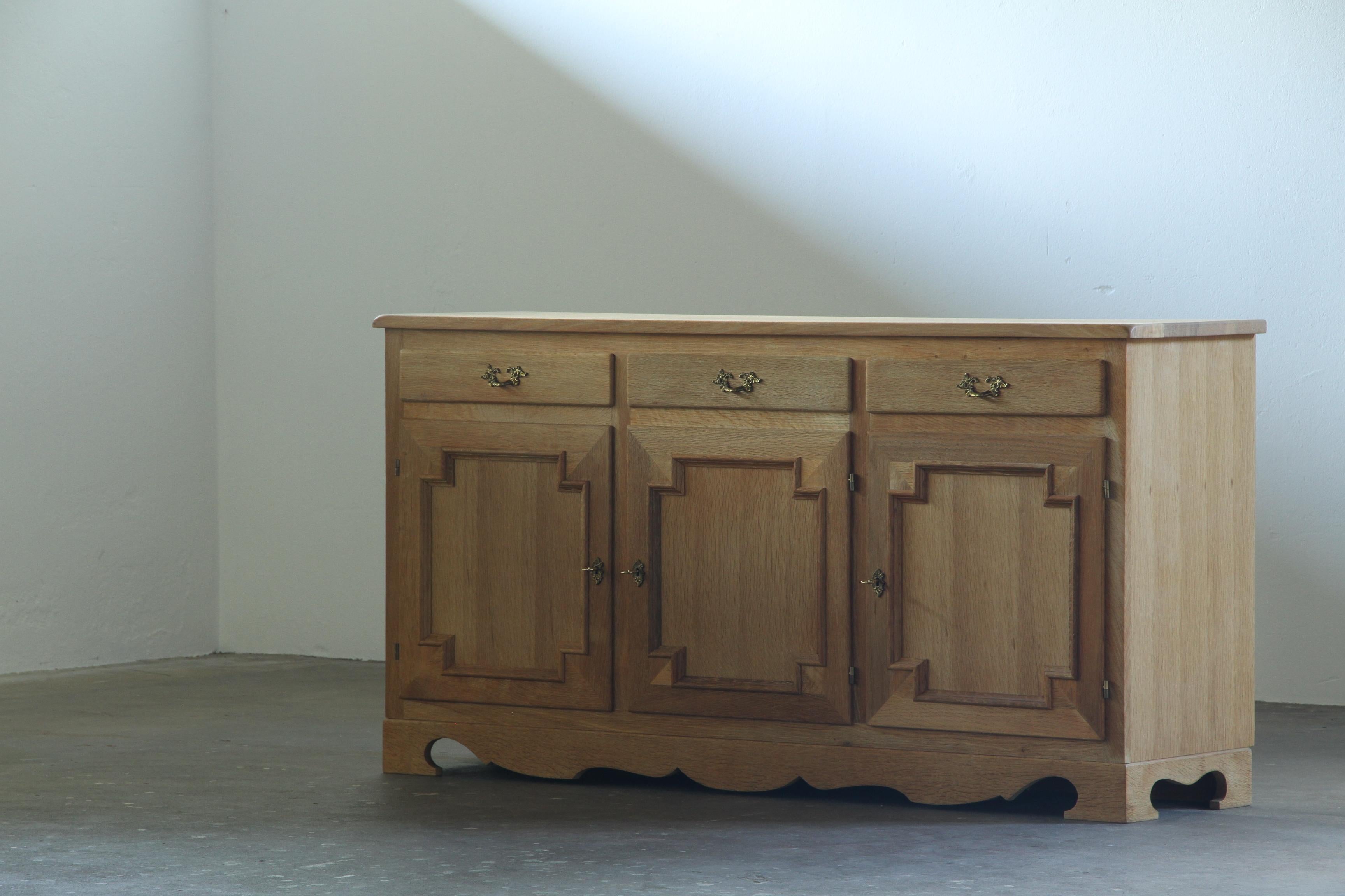 Danish_Brutalist_Solid_Oak_Sideboard_with_Carved_Doors_and_Three_Drawers,_Attributed_to_Henning_Kjærnulf,_1960s