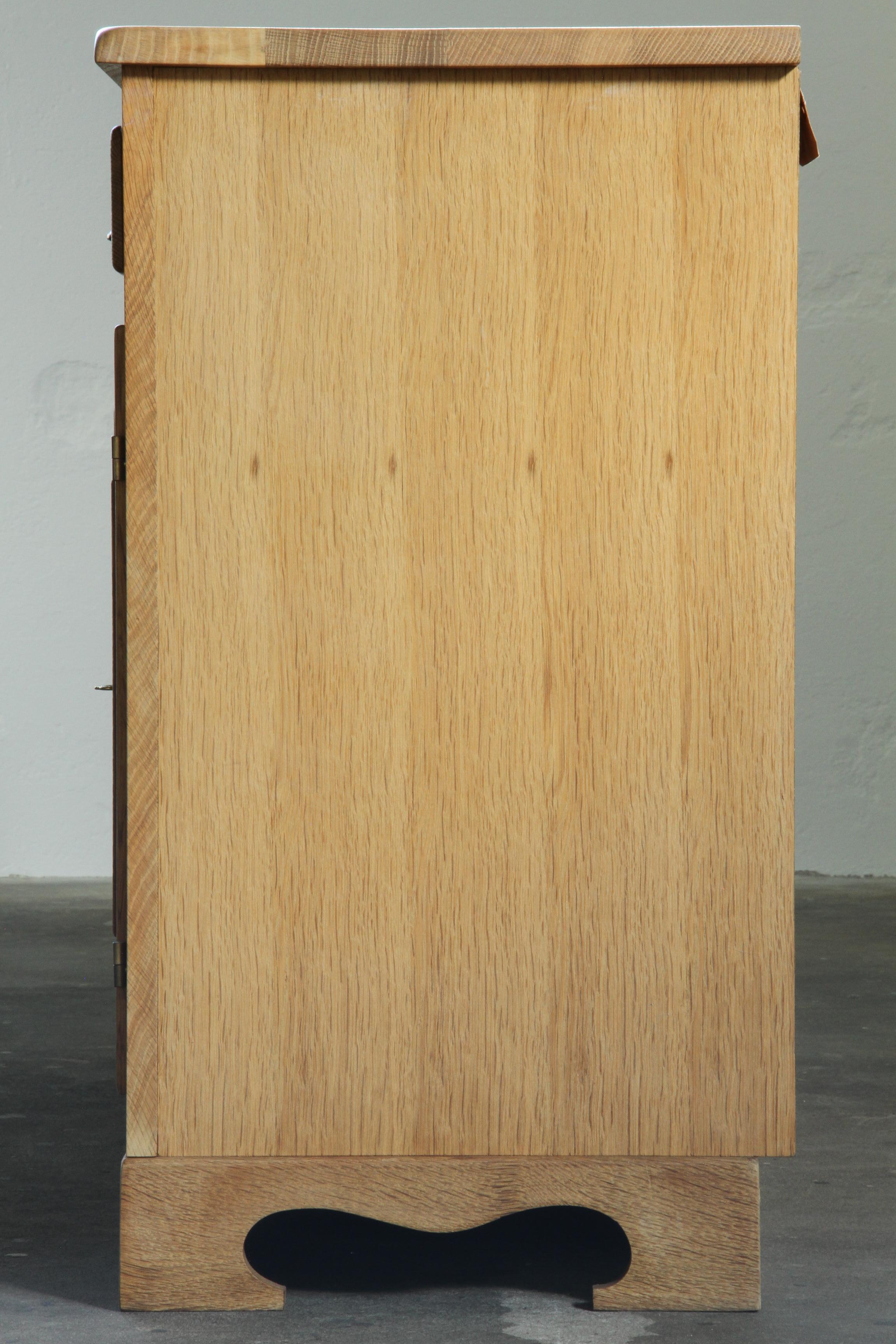 Danish_Brutalist_Solid_Oak_Sideboard_with_Carved_Doors_and_Three_Drawers,_Attributed_to_Henning_Kjærnulf,_1960s