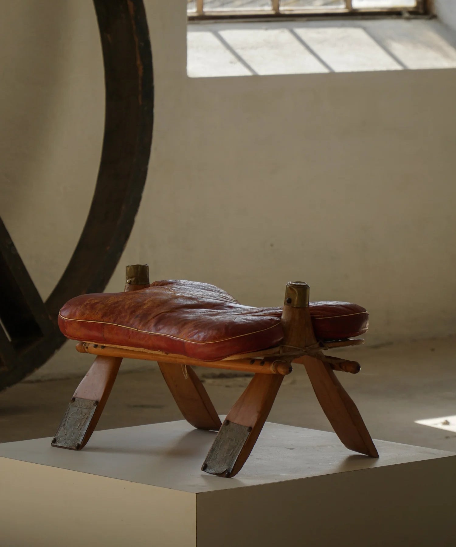 Vintage_Moroccan_Camel_Saddle_Footstool_in_Dark_Red_Upholstery,_Mid_20th_Century