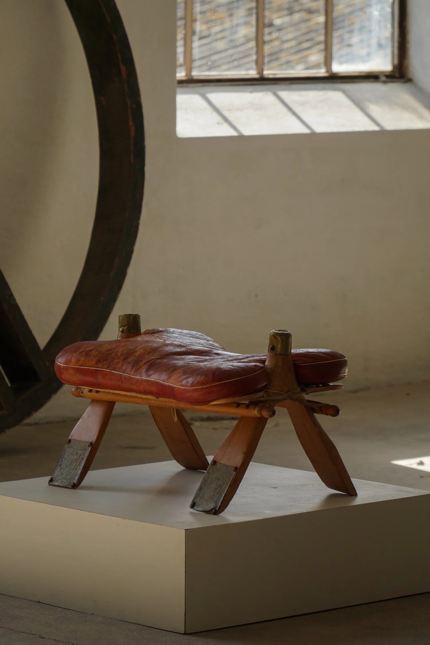 Vintage_Moroccan_Camel_Saddle_Footstool_in_Dark_Red_Upholstery,_Mid_20th_Century