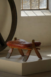Vintage_Moroccan_Camel_Saddle_Footstool_in_Dark_Red_Upholstery,_Mid_20th_Century