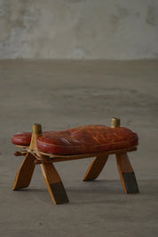 Vintage_Moroccan_Camel_Saddle_Footstool_in_Dark_Red_Upholstery,_Mid_20th_Century