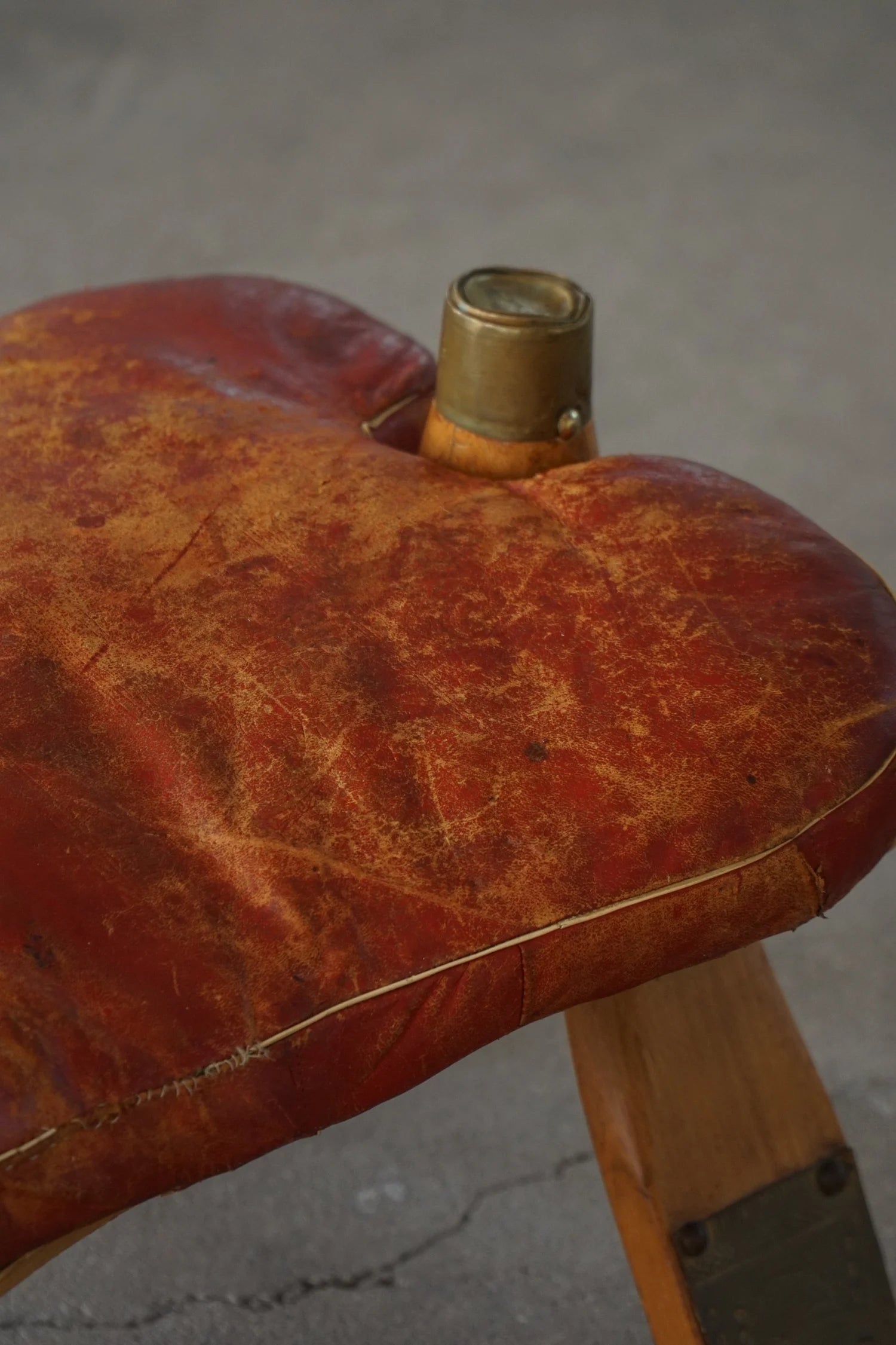 Vintage_Moroccan_Camel_Saddle_Footstool_in_Dark_Red_Upholstery,_Mid_20th_Century