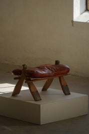 Vintage_Moroccan_Camel_Saddle_Footstool_in_Dark_Red_Upholstery,_Mid_20th_Century